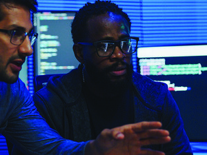 two male coworkers working in tech office