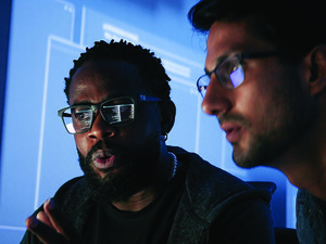 Colleagues reviewing information on computer