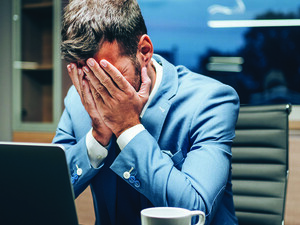 Employee with head in hands