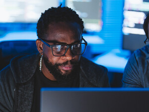 Two men looking at computer screen
