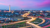 Washington DC skyline at dusk with traffic moving on highways in streams of lights 
