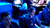 Operations Specialist’s 3rd Class Joseph Quintana, left, of Riverside, Calif., Sara Hacket, center, of San Jose, Calif., and Operations Specialist 2nd Class Ryan Archer of Sarasville, Ohio, monitor Global Command Control Systems (GCCS) in the Combat Direction Center (CDC) aboard the Nimitz-class aircraft carrier USS John C. Stennis 