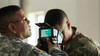 U.S. Army Reservists learn how to use iris scans to identify personnel during a training exercise.