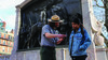 park ranger helps tourist with app in front of Glory memorial
