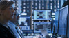 women watches monitor in mission-critical center