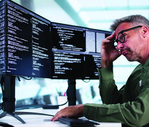 Man looking at coding on computer